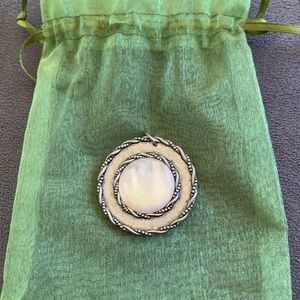 Pearl and silver colored necklace pendant